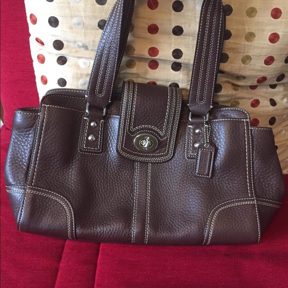 New Coach handbag in brown color.